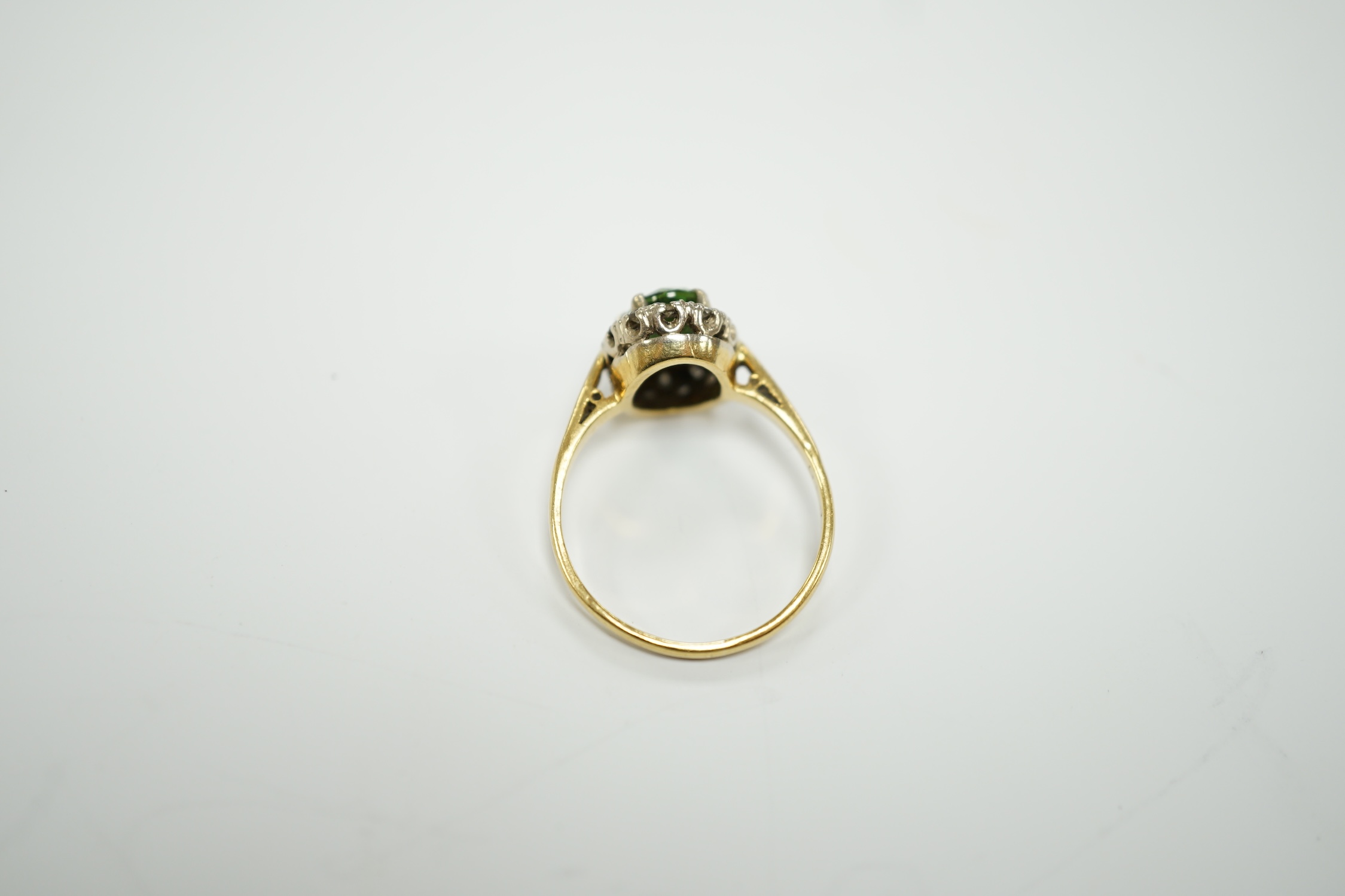 A modern 18ct gold, green tourmaline and diamond set oval cluster ring, size O/P, gross weight 3.5 grams.